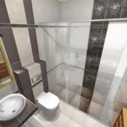 Wizualizacja łazienki z kabiną prysznicową typu walk-in, umywalką nablatową na brązowym blacie, toaletą oraz lustrem w złotej ramie. Na ścianach pionowe pasy beżowych, brązowych i czarnych płytek.