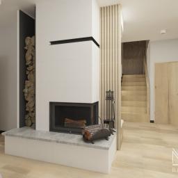 Blanka Mróz - Wizualizacja wnętrza z kominkiem obłożonym białymi płytkami, drewnem ułożonym dekoracyjnie obok, jasną drewnianą podłogą i schodami w tle.