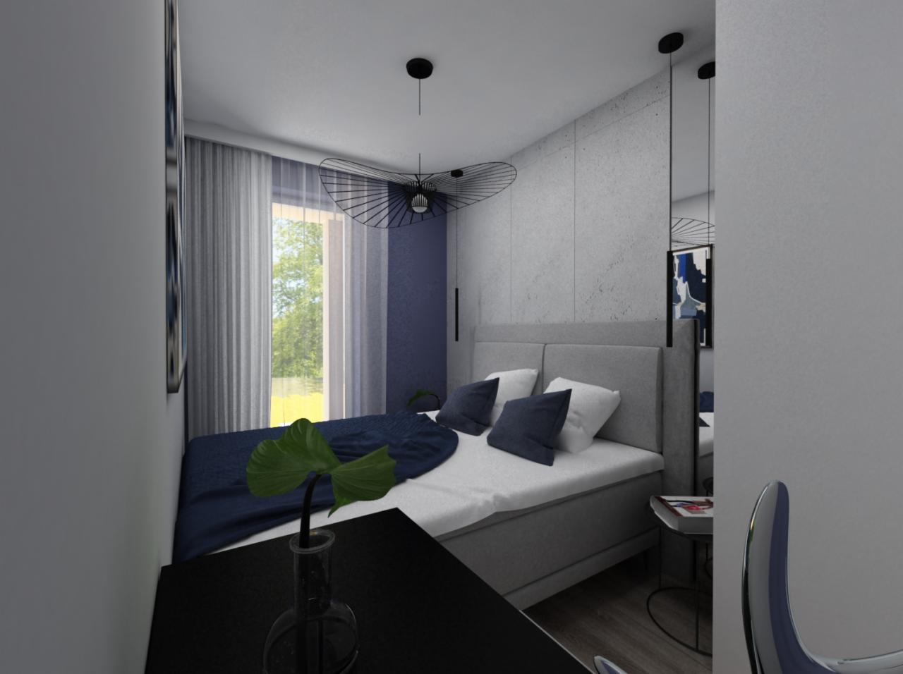 Nowoczesna sypialnia w odcieniach szarości i granatu z dekoracyjną lampą i rośliną w szklanym wazonie na pierwszym planie.