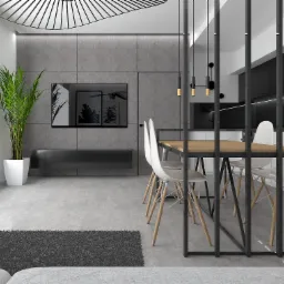 Nowoczesne wnętrze mieszkania z drewnianym stołem, białymi krzesłami, szarą ścianą i rośliną w białej donicy, oświetlone wiszącymi lampami.