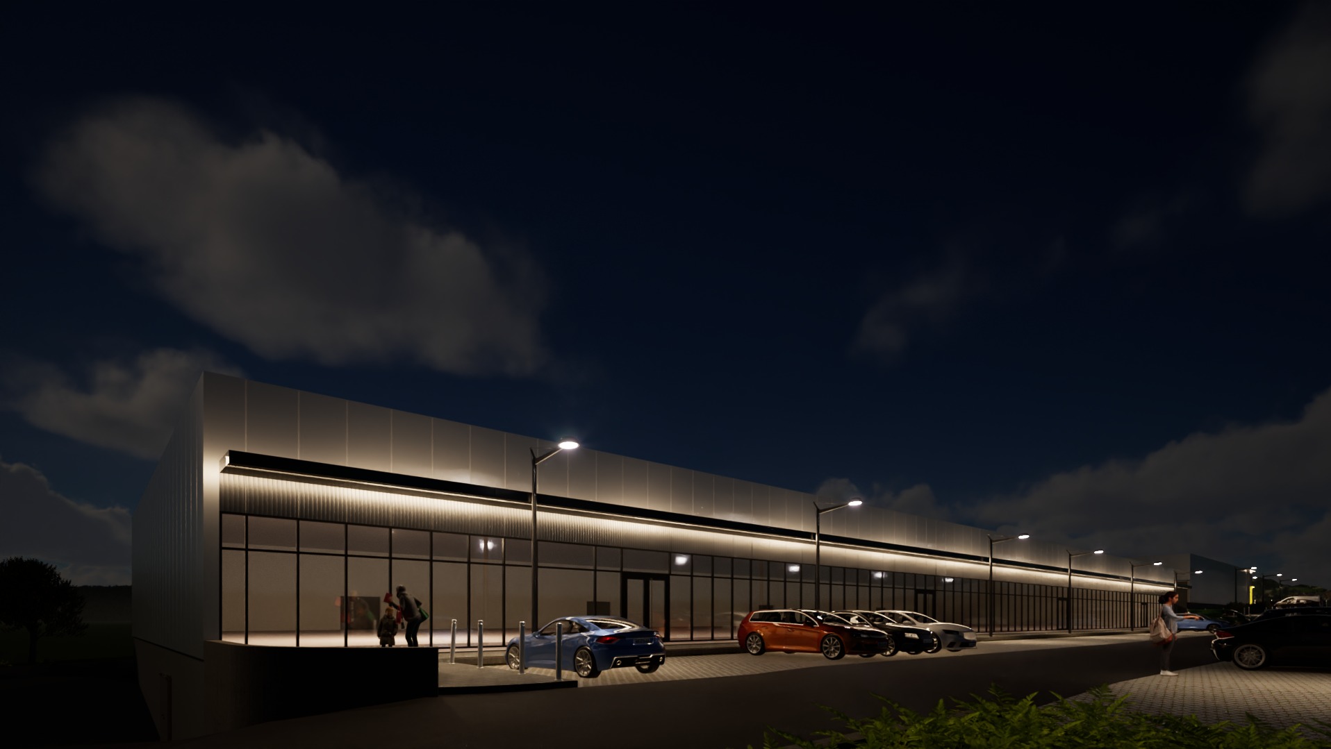 Nocny widok budynku usługowego z podświetloną elewacją, zaparkowanymi samochodami i sylwetkami ludzi wewnątrz. Nowoczesna architektura z dużymi przeszkleniami.