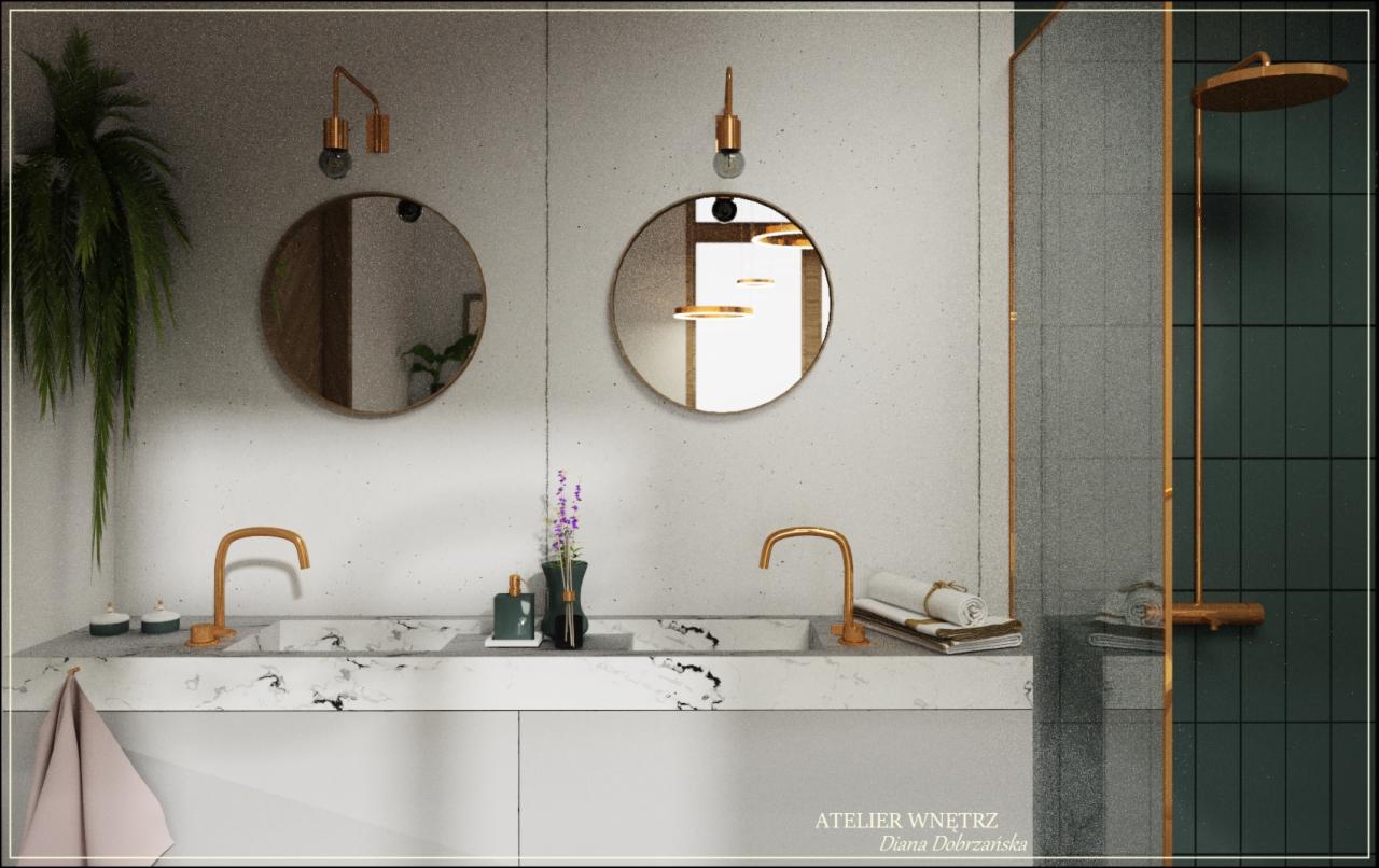 Nowoczesna łazienka z dwoma okrągłymi lustrami, marmurowym blatem, złotymi bateriami i kabiną prysznicową z ciemnozieloną glazurą oraz złotymi profilami.