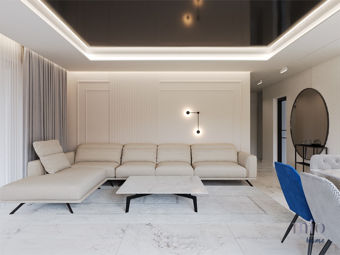 Jasny salon z narożną sofą w odcieniach beżu, marmurowym stolikiem kawowym, ścianą z dekoracyjnymi panelami i czarnym, błyszczącym sufitem z oświetleniem LED.