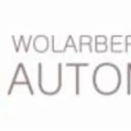 Logo firmy Wolarberg Automatics z abstrakcyjnym symbolem graficznym w kolorach szarym i pomarańczowym.