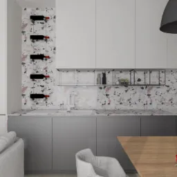 Wizualizacja kuchni z szarymi szafkami, blatem z terazzo, białym zlewem i baterią, oraz półkami z butelkami wina. Na stole wazon z czerwonymi tulipanami. W tle widoczny fragment sofy.