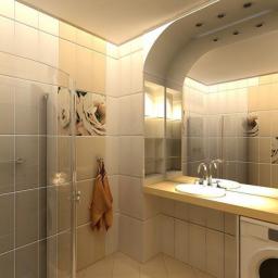 Haverim Galyna Obushok - Jasna łazienka z kabiną prysznicową, umywalką wpuszczoną w blat i pralką pod blatem, dekoracyjne płytki z motywem kwiatowym, lustro w łuku.