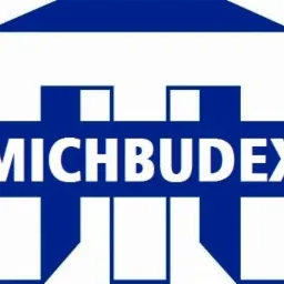 Logo firmy budowlanej MICBUDEX w kolorze niebieskim, stylizowane na kształt domu z dachem.