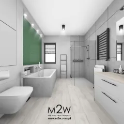 Nowoczesna łazienka z wanną obudowaną szarym betonem, kabiną prysznicową typu walk-in i ścianą z zielonej jodełki nad wanną, oświetlona punktowymi lampami sufitowymi.