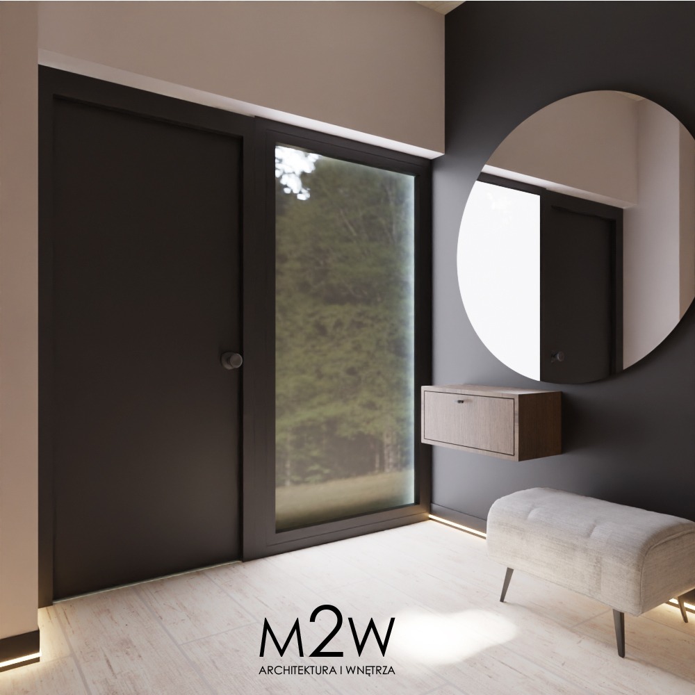 Nowoczesny przedpokój z czarnymi drzwiami, okrągłym lustrem, wiszącą szafką z drewna i tapicerowanym siedziskiem na tle ciemnoszarej ściany, oświetlony listwami LED przy podłodze.