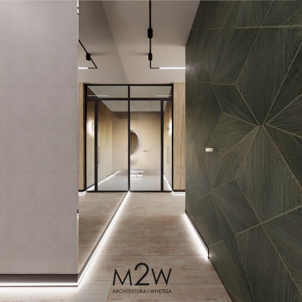 Nowoczesny korytarz z podświetlaną podłogą, geometryczną ścianą z ciemnego drewna i przeszklonym wejściem do dalszej części domu z okrągłym oknem.