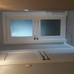 Białe, dwuskrzydłowe drzwi przesuwne z matowym szkłem, zamontowane w nowoczesnym wnętrzu z panelami podłogowymi i designerską lampą.