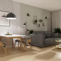Wizualizacja salonu z jadalnią: szara sofa, biały stolik kawowy, stół z krzesłami, geometryczna tapeta, wisząca lampa, dekoracje ścienne i duże okno z zasłonami.