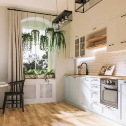 Jasna kuchnia w stylu skandynawskim z błękitnymi szafkami, drewnianym blatem, białymi płytkami na ścianie, wiszącymi roślinami w oknie i okrągłym stołem z czarnymi krzesłami.