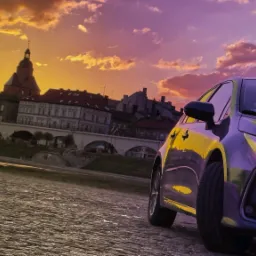 Nowoczesna taksówka na brukowanej ulicy z widokiem na miasto i zachodzące słońce.