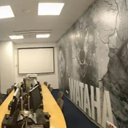 Wnętrze biura we Wrocławiu z fototapetami przedstawiającymi motywy filmowe i mapę, zaprojektowane w ramach identyfikacji wizualnej firmy.