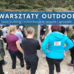 Circinus Training Center Adam Pluciński - Warsztaty outdoor: grupa osób na piasku, w tle las. Uczestnicy w trakcie ćwiczenia team building, komunikacja w zespole i sprzedaż. Widoczny napis na bluzie.