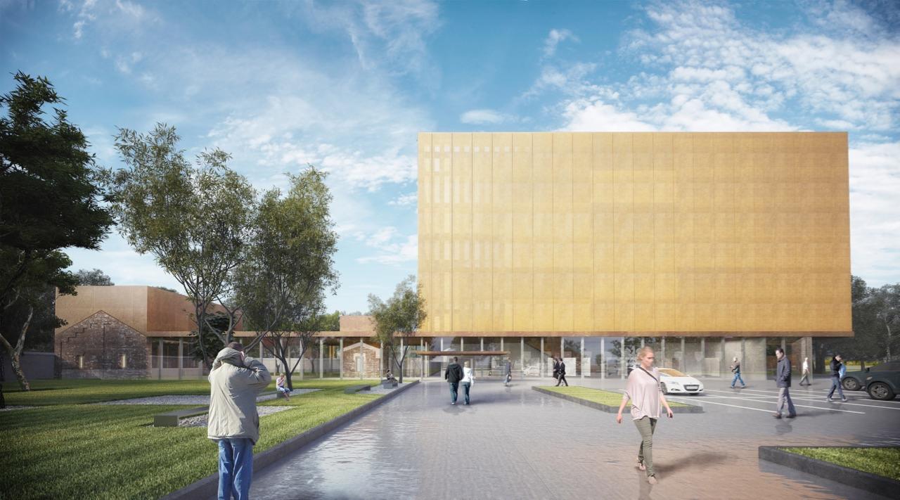 Wizualizacja budynku usługowego z elewacją w odcieniach złota, otoczonego zielenią i spacerującymi ludźmi, z widocznym fragmentem starszego, ceglanego budynku w tle.