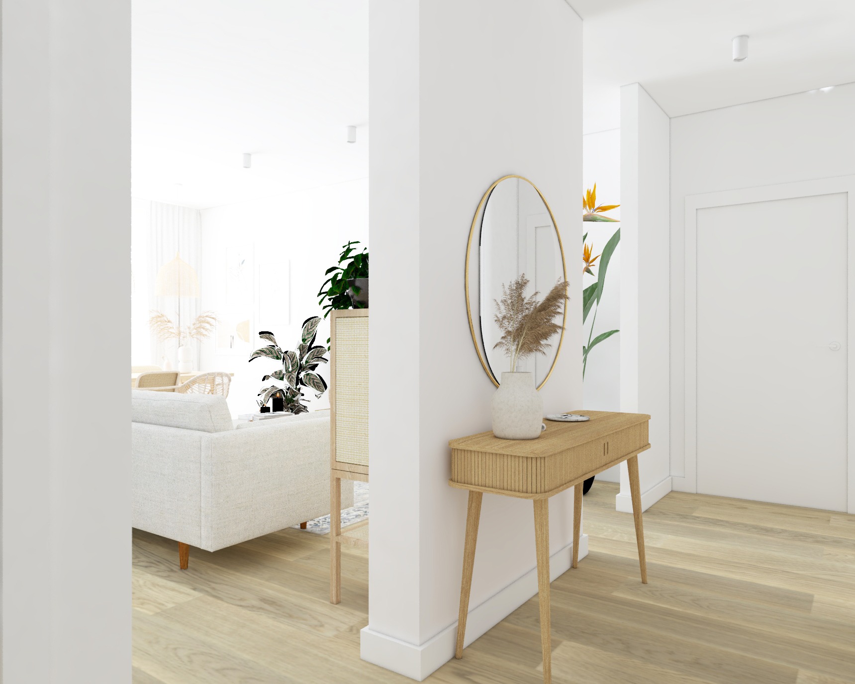 Jasne wnętrze mieszkania w stylu skandynawskim: kremowa sofa, drewniana komoda z rattanowymi frontami, okrągłe lustro nad konsolą z dekoracyjnym wazonem z suszem, widok na salon z jadalnią.