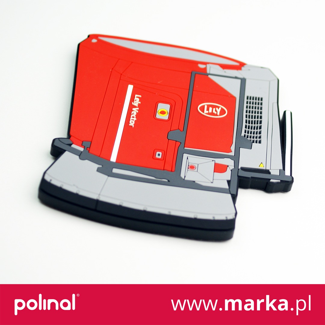 Gumowa, trójwymiarowa, czerwono-szara forma maszyny rolniczej Lely Vector, leżąca na białym tle, z widocznym logo firmy.