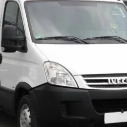 Biały samochód dostawczy marki Iveco z wysokim dachem, zaparkowany na zewnątrz, widok z przodu.