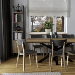 Nowoczesna jadalnia w Nowym Sączu z drewnianym stołem na czarnej podstawie, szarymi krzesłami z jasnymi nogami, wzorzystym dywanem w odcieniach bieli i szarości oraz regałem z dekoracjami i książkami.