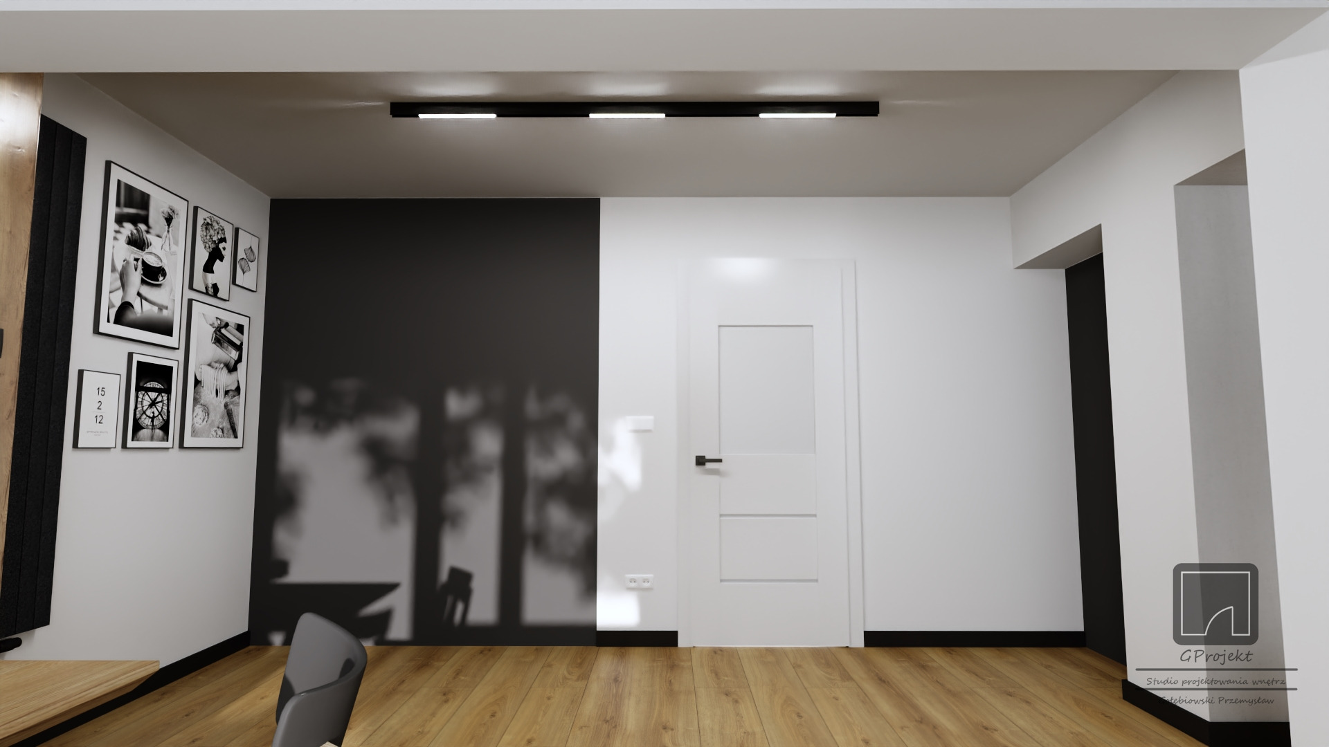Minimalistyczne wnętrze z czarno-białymi akcentami: czarna ściana z galerią grafik, białe drzwi z czarną klamką, drewniana podłoga, czarne listwy przypodłogowe i oświetlenie sufitowe.