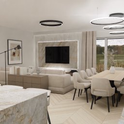 Davinci Studio Marcin Pajewski - Wizualizacja przestronnego salonu z jadalnią w neutralnej kolorystyce, akcenty w postaci okrągłych lamp sufitowych i marmurowego blatu kuchennego.