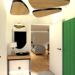 Nowoczesny przedpokój z elementami drewna: wiszące dekoracje sufitowe, owalne lustro, konsola z lampką i zielonym akcentem, widok na salon z szarą sofą.