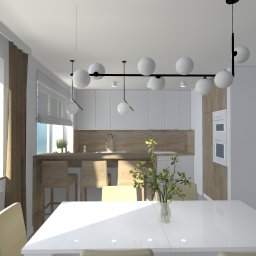 Kara design. Pracownia Projektowa K. Pruszewicz - Wnętrze nowoczesnej kuchni z białymi szafkami, drewnianym blatem i wyspą z hokerami, widok z jadalni z białym stołem i krzesłami w kolorze ecru, oświetlonej wiszącą lampą z kulistymi kloszami,...