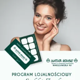 Uśmiechnięta kobieta z kartą lojalnościową programu 'Lekki Zysk' Natur House, eksperta w reedukacji żywieniowej.