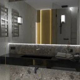 Nowoczesna łazienka z czarnym blatem umywalki, marmurową ścianą, podświetlanym lustrem i grzejnikiem drabinkowym