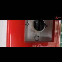 Czerwona obudowa z białym panelem sterowania, strzałkami kierunkowymi i symbolem dłoni wskazującej w dół, etykieta 'SID Elektromet' na dole.