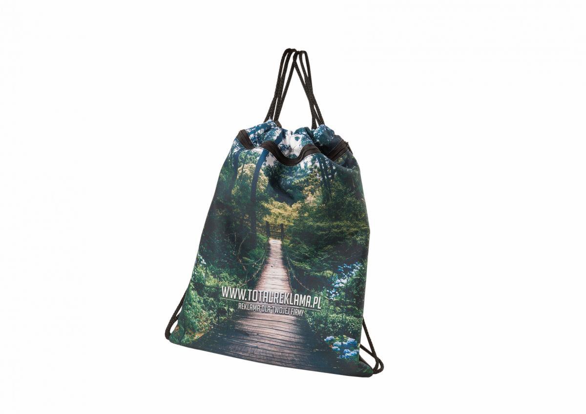 Materiałowy worek ze sznurkami, z nadrukiem drewnianej kładki w lesie i adresem strony internetowej firmy reklamowej.