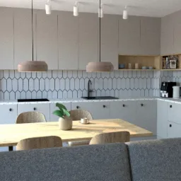 Szara kuchnia z drewnianym stołem i krzesłami, nad stołem wiszą lampy, na blacie czajnik i ekspres do kawy, na stole stoi wazon z rośliną.