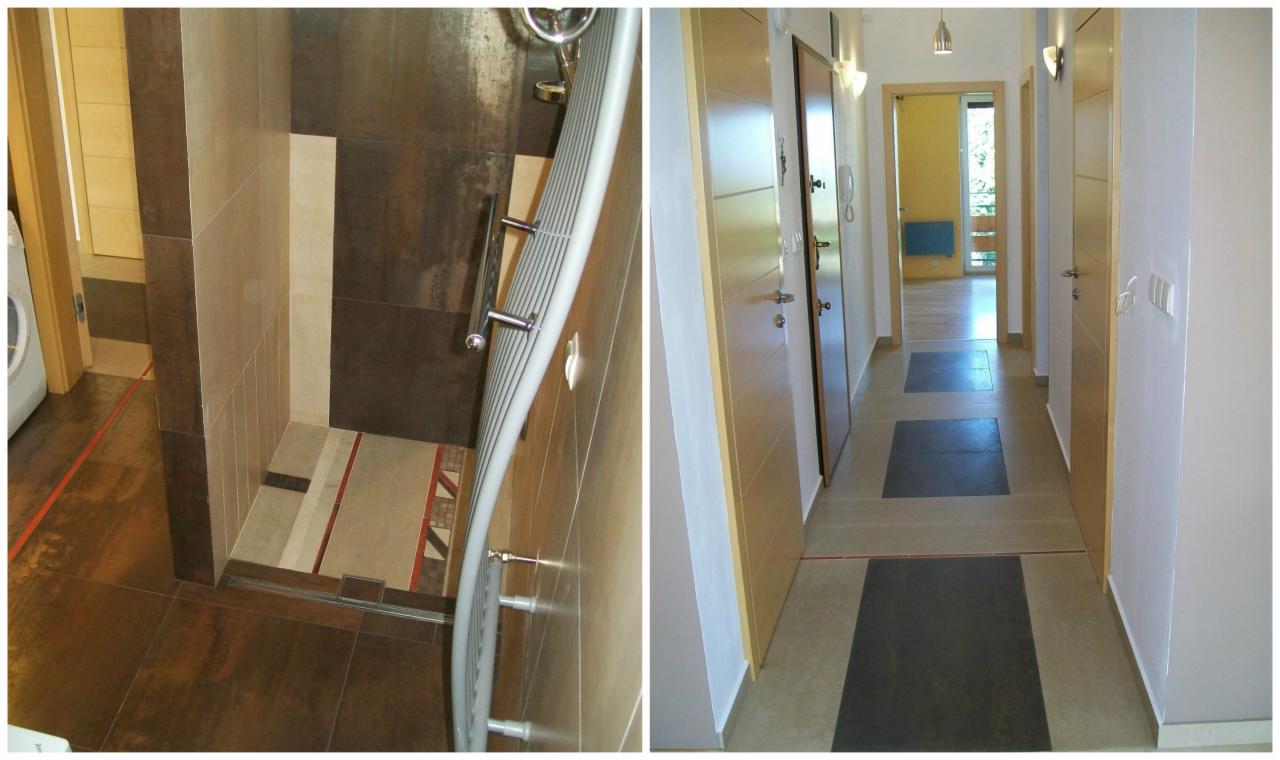 Nowoczesna łazienka z kabiną prysznicową typu walk-in, wykończona brązowo-beżowymi płytkami o zróżnicowanej fakturze, oraz korytarz z jasnymi ścianami i ciemnymi, kwadratowymi wstawkami w podłodze,...