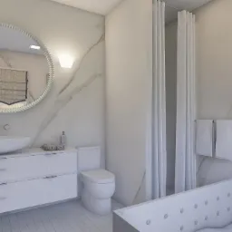 Jasna łazienka z okrągłym lustrem, marmurową ścianą, białą szafką pod umywalką, toaletą i wanną z hydromasażem; roślina doniczkowa na półce.