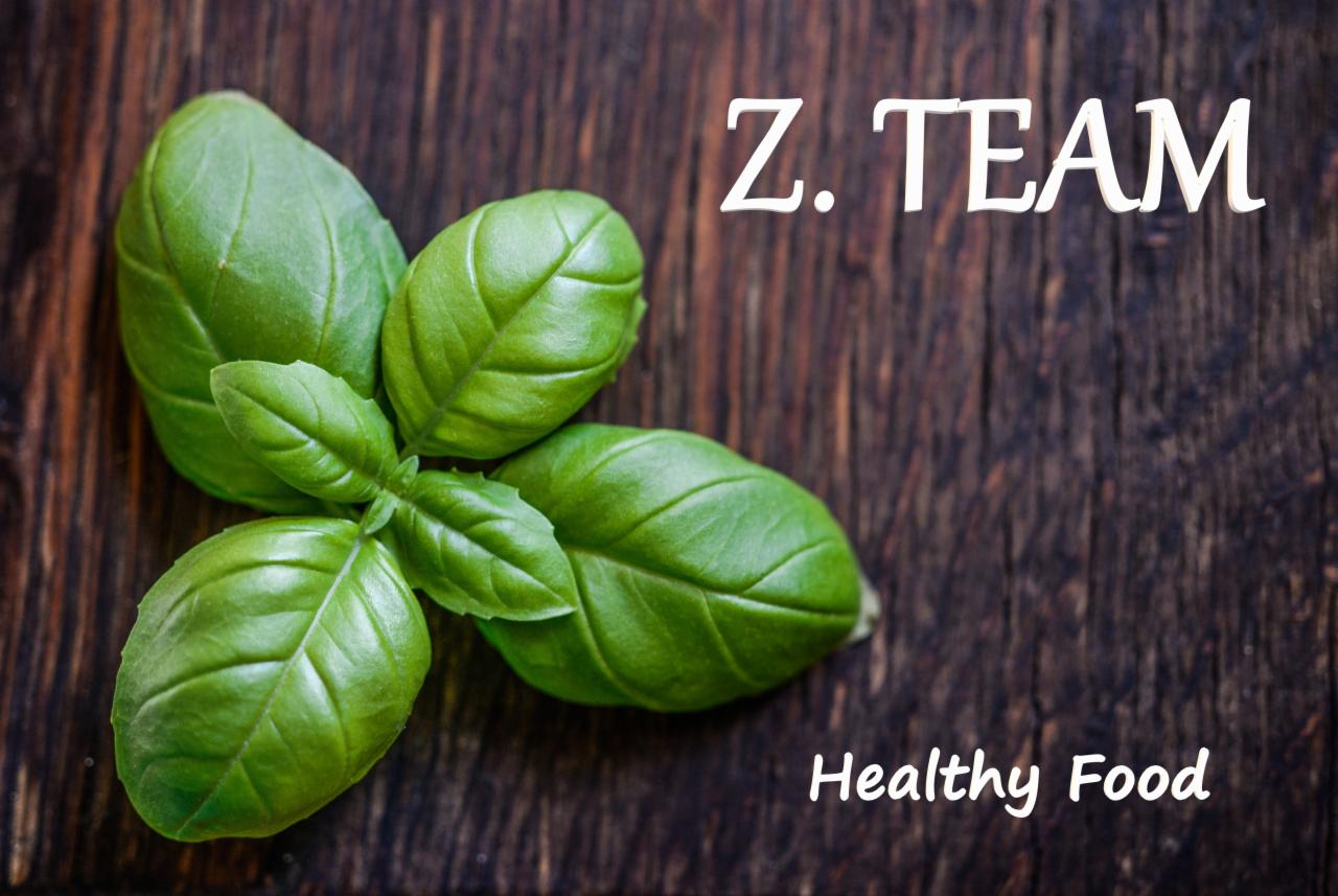 Świeża bazylia na ciemnym, drewnianym tle z napisem 'Z. TEAM Healthy Food'.