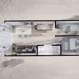 Rzut z góry na wnętrze małego domu modułowego z dwiema sypialniami, salonem, kuchnią i łazienką, otoczonego piaskiem.