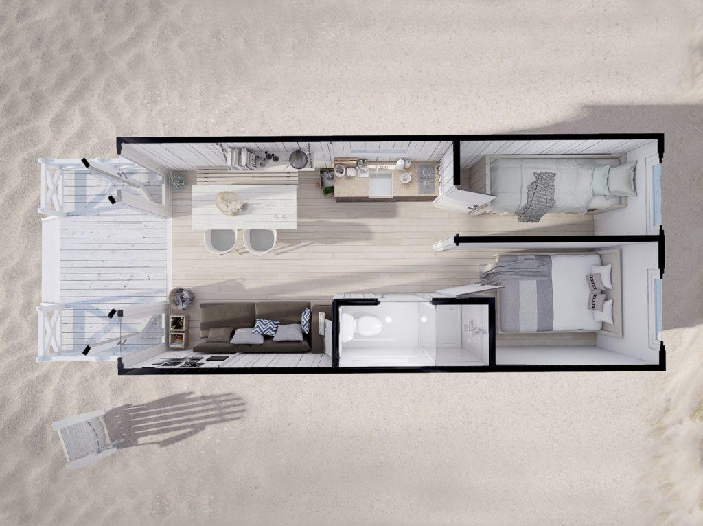 Rzut z góry na wnętrze małego domu modułowego z dwiema sypialniami, salonem, kuchnią i łazienką, otoczonego piaskiem.