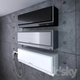 Trzy klimatyzatory Mitsubishi Electric w kolorach czarnym, srebrnym i białym zamontowane na szarej, betonowej ścianie z widocznymi śladami szalunku i gniazdkiem elektrycznym z podłączonymi kablami.