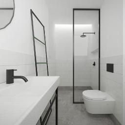 Plan A - Minimalistyczna łazienka w bieli i czerni: umywalka z czarną armaturą, drabinka na ręczniki z zielonymi akcentami, kabina prysznicowa ze szklaną ścianą i wisząca toaleta.