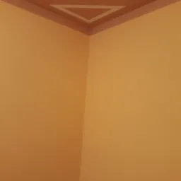 Pomarańczowe ściany w rogu pokoju z dekoracyjnym, trójkątnym wzorem na suficie, obramowanym brązowym paskiem.