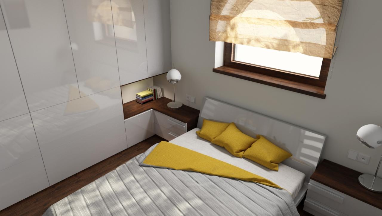 Pokój z łóżkiem z szarą pościelą i żółtymi poduszkami, szafa z białymi, błyszczącymi frontami, drewniany blat z książkami i lampką, roleta w oknie.