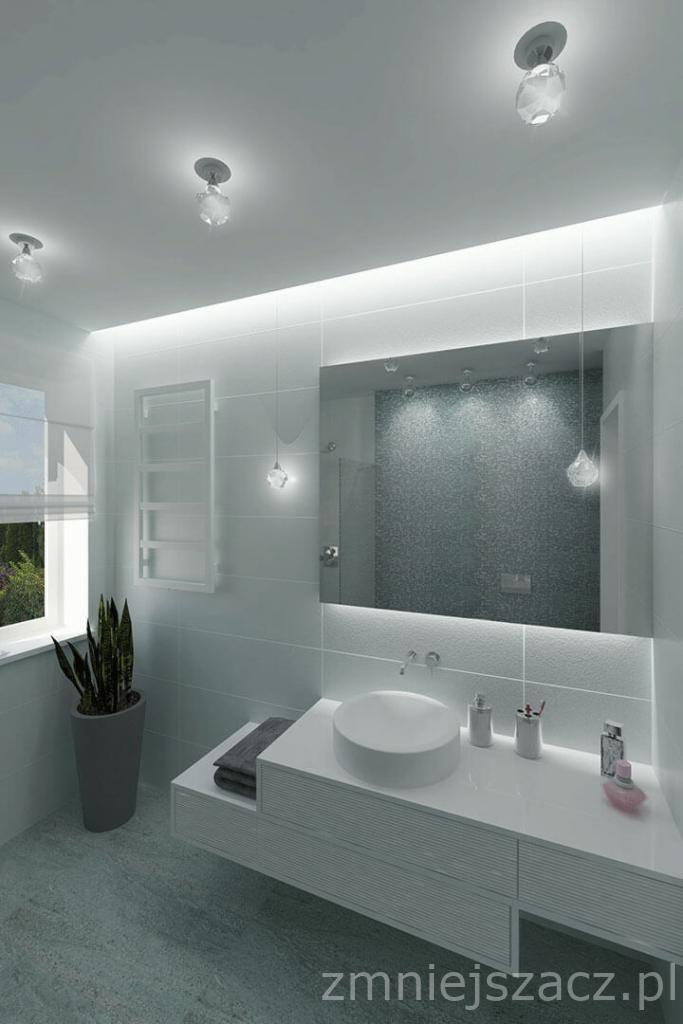 Nowoczesna łazienka w chłodnej tonacji bieli i szarości, z okrągłą umywalką nablatową, podświetlanym lustrem i minimalistycznymi lampami wiszącymi z kryształkami