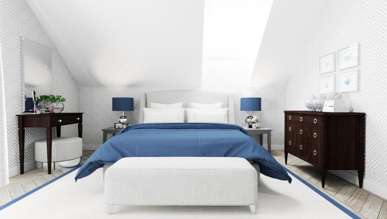 Jasna sypialnia na poddaszu z łóżkiem przykrytym niebieską narzutą, białym pufem, ciemną toaletką i komodą na tle geometrycznej tapety.