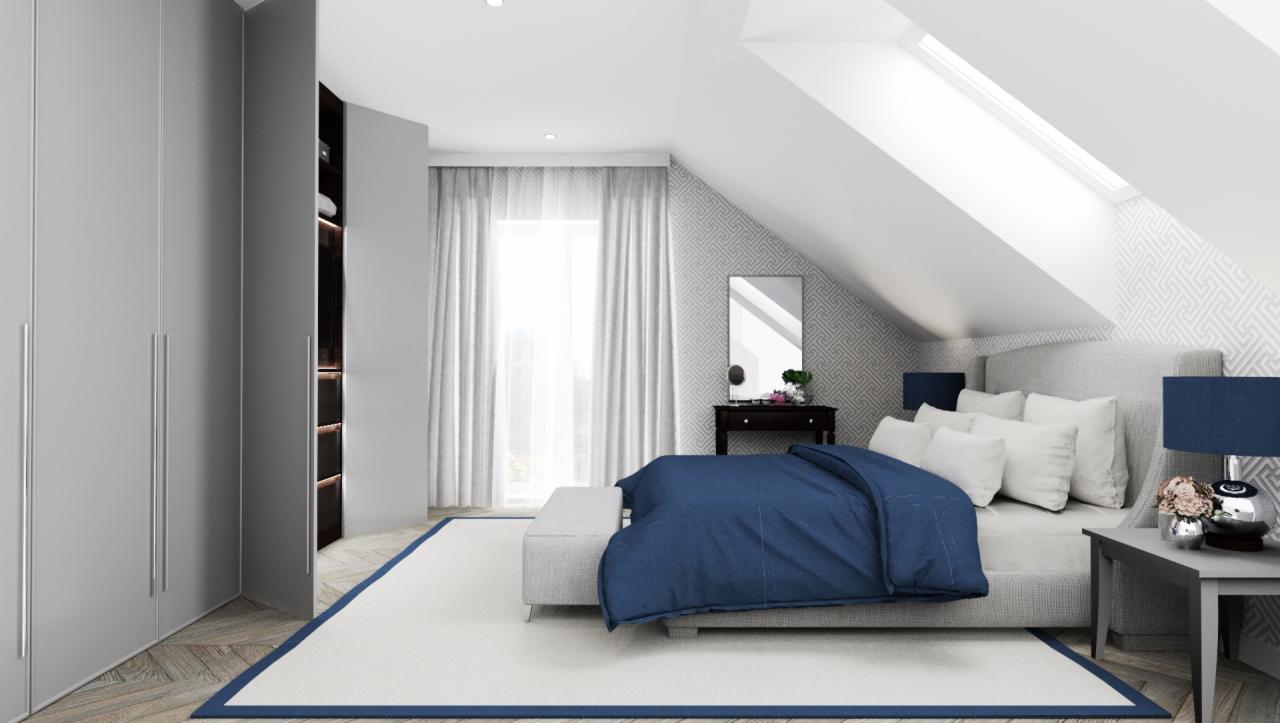 Sypialnia na poddaszu z łóżkiem z szarym wezgłowiem, granatową narzutą, białymi poduszkami, szarą szafą i oknem dachowym.