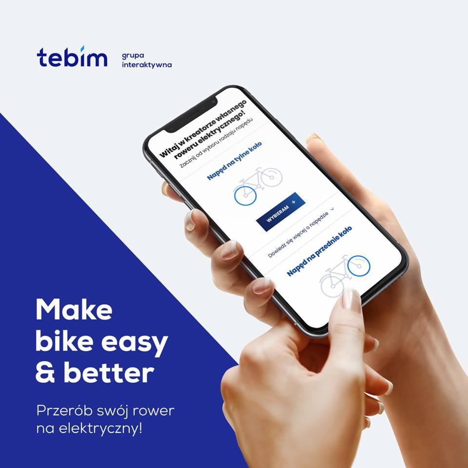 Dłoń wskazująca na ekran smartfona prezentującego kreator wyboru napędu elektrycznego do roweru, z opcjami napędu na tylne i przednie koło, obok logo firmy Tebim.