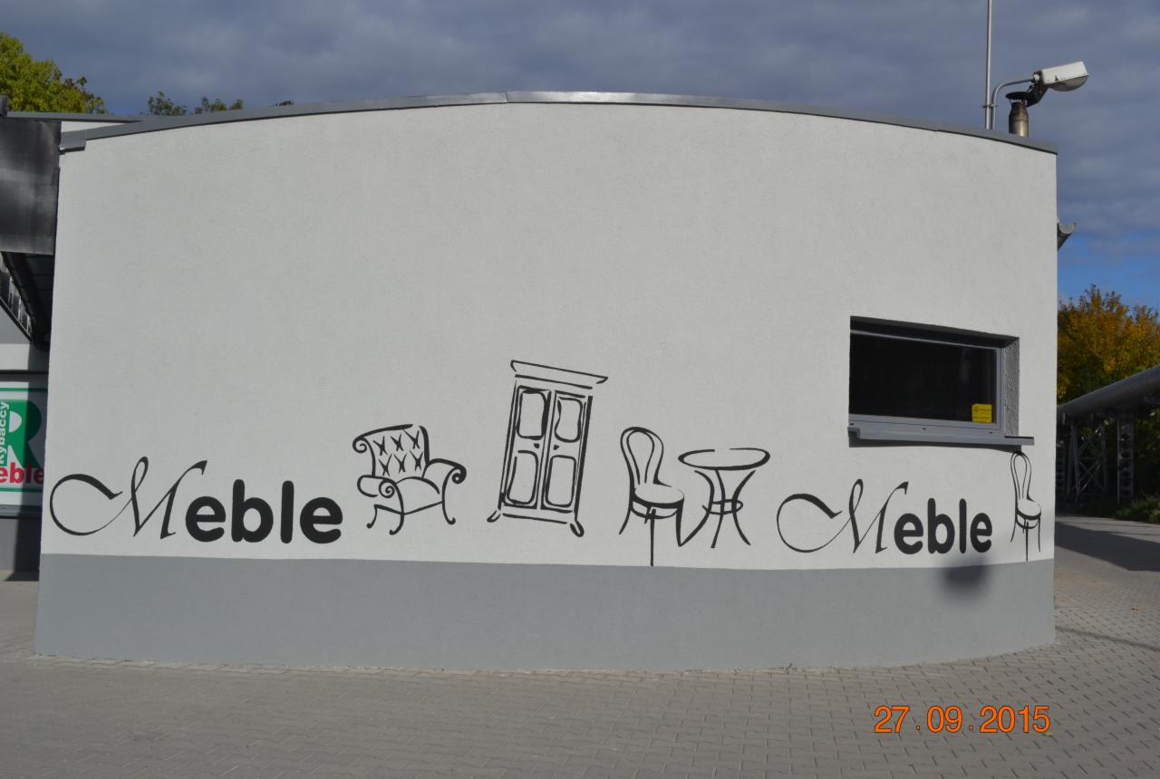 Ściana budynku z rysunkami mebli: fotel, szafa, stół z krzesłem i napisem 'Meble' w ozdobnej czcionce.