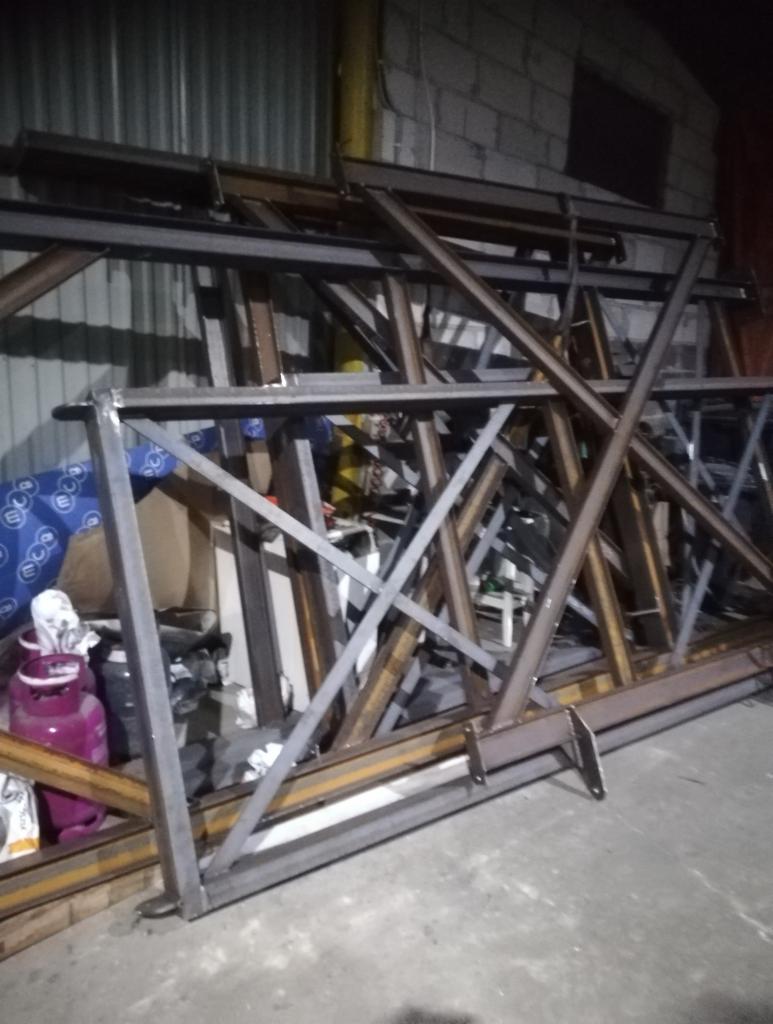 Konstrukcja stalowa z profili, częściowo pomalowana farbą antykorozyjną, leżąca na betonowej posadzce w warsztacie, widoczne ślady spawania.