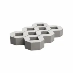 Szare ażurowe elementy betonowe ułożone w regularny wz&oacute;r na białym tle, widoczne otwory w każdym elemencie.